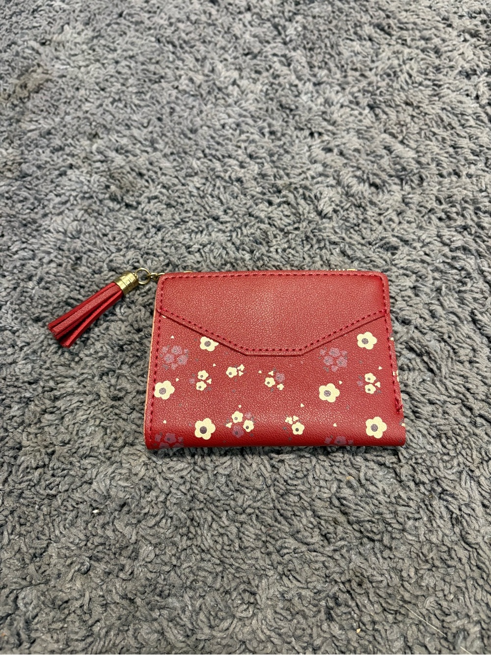 NWOT deep red floral wallet with a couple card slots inside and a zipper pouch
